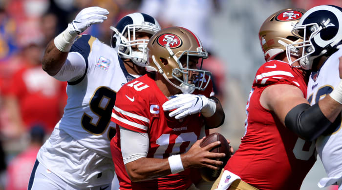 Oct 13, 2019; Los Angeles, CA, USA; San Francisco 49ers quarterback Jimmy Garoppolo (10) is sacked by Los Angeles Rams defensive tackle Aaron Donald (left) during the first quarter at Los Angeles Memorial Coliseum. Mandatory Credit: Orlando Ramirez-USA TODAY Sports